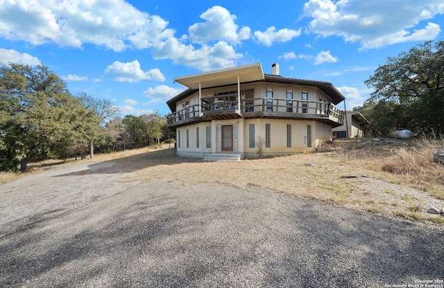 8060 Prue, San Antonio, TX 78249 - back of property featuring a balcony and a chimney