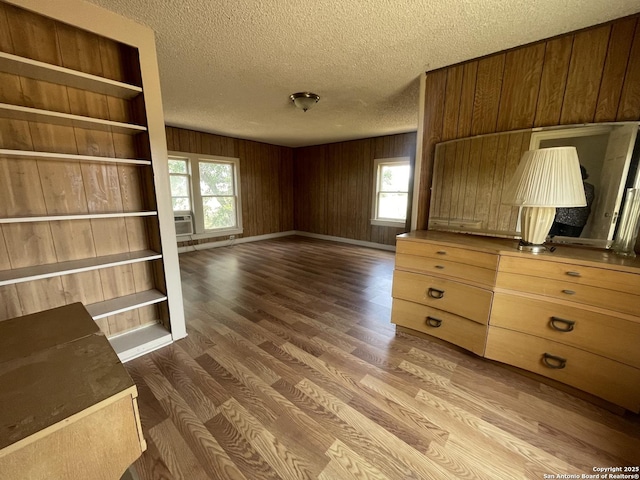 8439 Gardner, San Antonio, TX 78263 - unfurnished living room featuring a textured ceiling, wood finished floors, and wooden walls