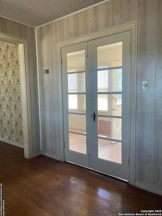 8439 Gardner, San Antonio, TX 78263 - doorway featuring french doors, dark wood-style flooring, a textured ceiling, and baseboards