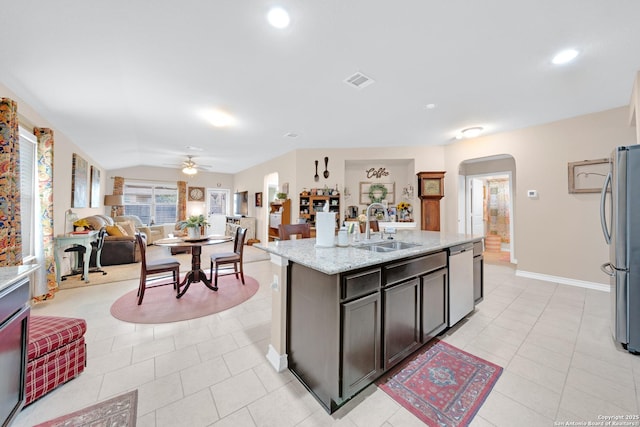 5903 Overture Dawn, San Antonio, TX 78252 - kitchen featuring a sink, arched walkways, appliances with stainless steel finishes, ceiling fan, and light tile patterned flooring