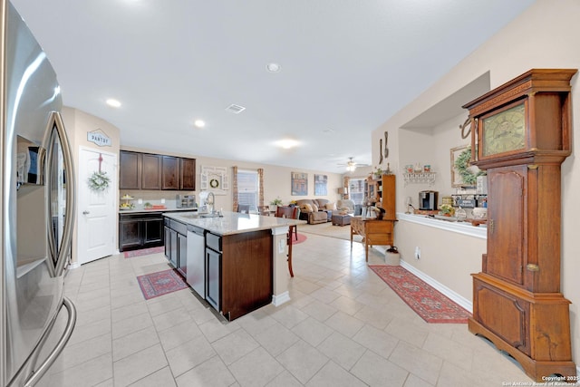 5903 Overture Dawn, San Antonio, TX 78252 - kitchen featuring appliances with stainless steel finishes, light tile patterned flooring, light countertops, a ceiling fan, and a sink