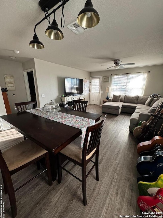 6914 Cozy, San Antonio, TX 78218 - dining area featuring a textured ceiling, ceiling fan, and wood finished floors