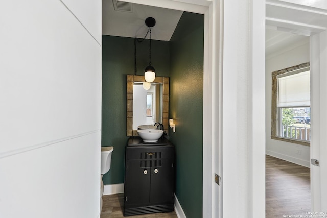 1526 Saint Marys, San Antonio, TX 78210 - half bath featuring wood finished floors, baseboards, vanity, and toilet