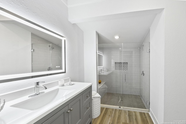 1526 Saint Marys, San Antonio, TX 78210 - full bath featuring wood finished floors, a stall shower, vanity, and a textured wall