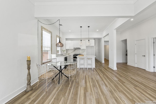 1526 Saint Marys, San Antonio, TX 78210 - dining space with baseboards, crown molding, light wood-style floors, and recessed lighting