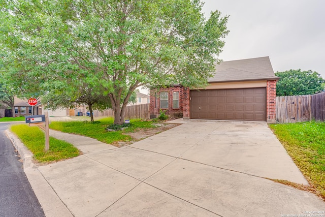 7111 Hallie, San Antonio, TX 78227 - obstructed view of property featuring a garage, driveway, and brick siding