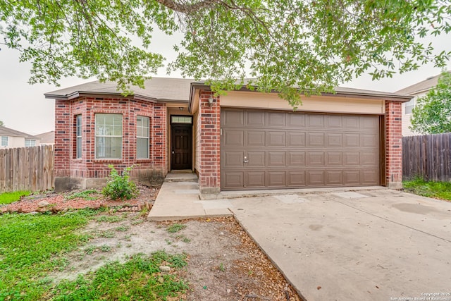 7111 Hallie, San Antonio, TX 78227 - view of front of house featuring brick siding, concrete driveway, and an attached garage