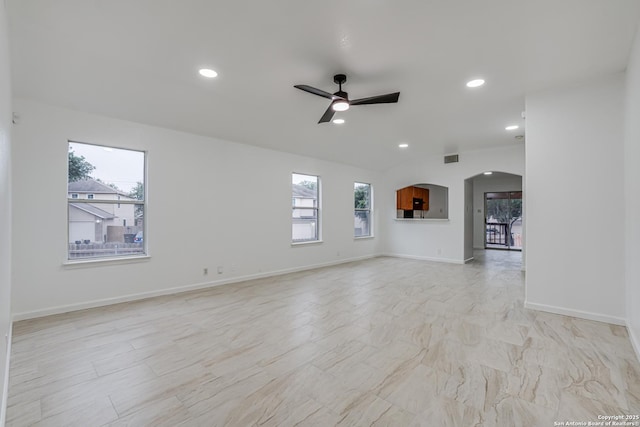 7111 Hallie, San Antonio, TX 78227 - unfurnished living room featuring arched walkways, ceiling fan, baseboards, and recessed lighting