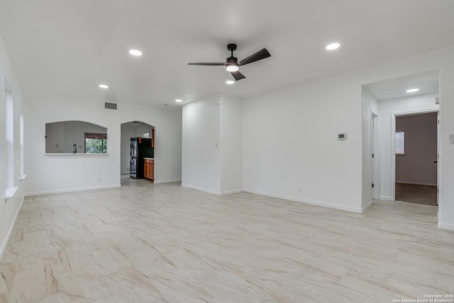 7111 Hallie, San Antonio, TX 78227 - unfurnished living room featuring arched walkways, recessed lighting, ceiling fan, and baseboards