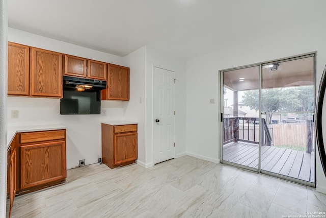 7111 Hallie, San Antonio, TX 78227 - kitchen with brown cabinetry, light marble finish flooring, light countertops, and baseboards