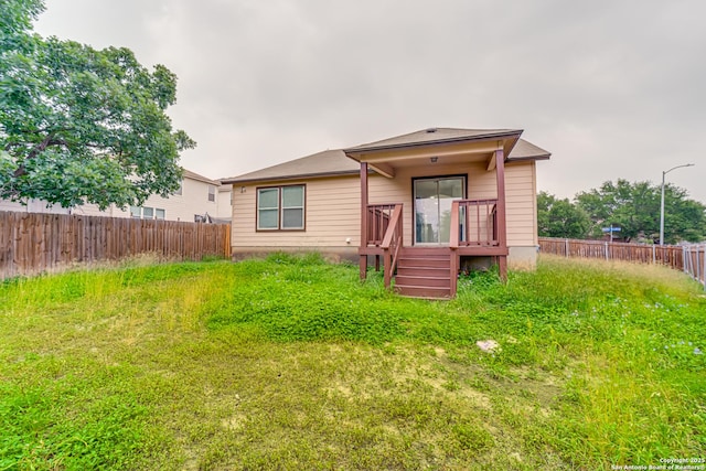 7111 Hallie, San Antonio, TX 78227 - rear view of house with a fenced backyard and a deck