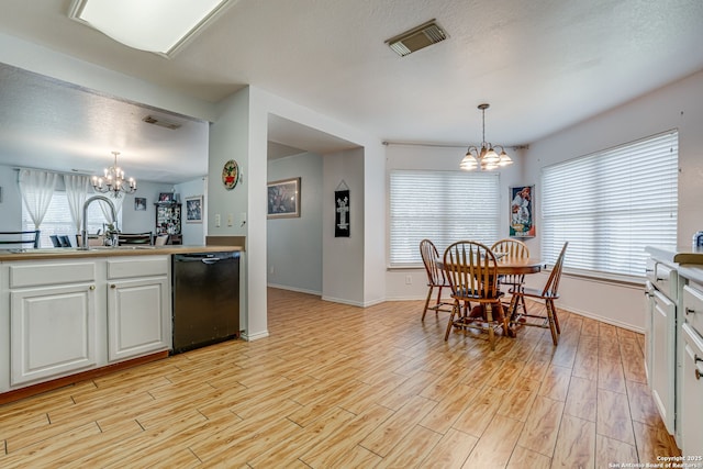 6459 Marlin Flts, San Antonio, TX 78244 - kitchen featuring a chandelier, black dishwasher, a sink, and light wood-style floors