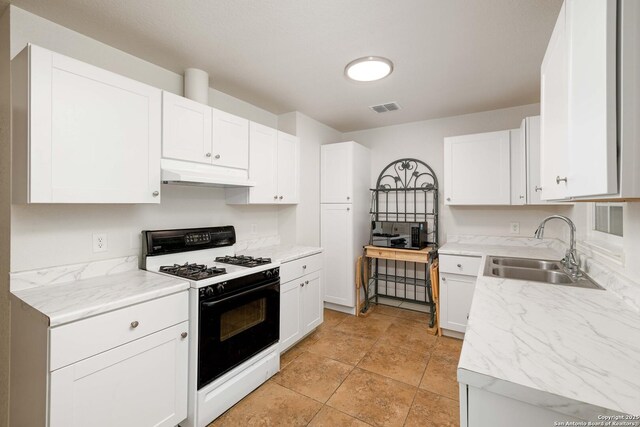 3702 La Sabre Dr, San Antonio, TX 78218 - kitchen with range with gas stovetop, under cabinet range hood, a sink, and white cabinetry