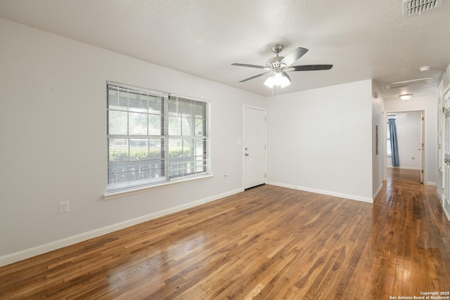 3702 La Sabre Dr, San Antonio, TX 78218 - spare room with wood finished floors, a ceiling fan, baseboards, and a textured ceiling