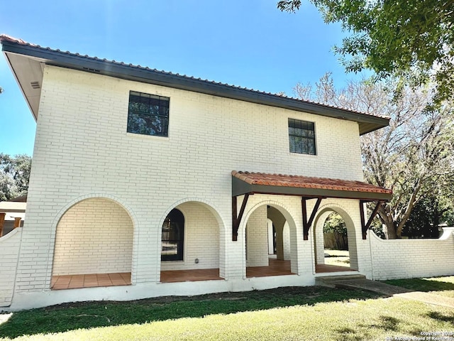 520 Sagecrest Dr, Hollywood Park, TX 78232 - rear view of house with brick siding, a lawn, and covered porch