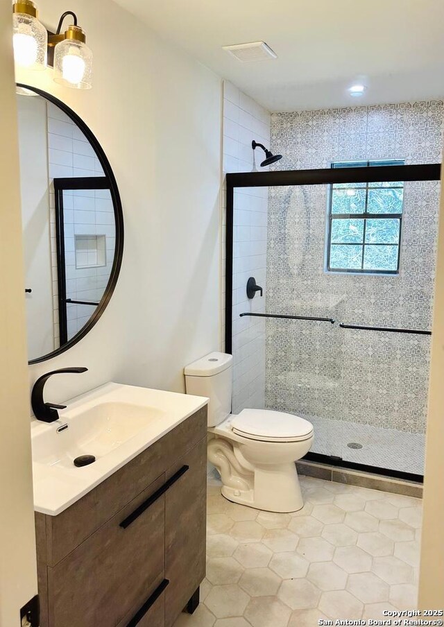 520 Sagecrest Dr, Hollywood Park, TX 78232 - full bath with vanity, toilet, a shower stall, and tile patterned floors