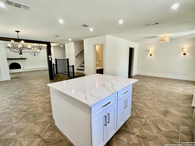 520 Sagecrest Dr, Hollywood Park, TX 78232 - kitchen with open floor plan, a chandelier, a center island, light stone countertops, and decorative light fixtures