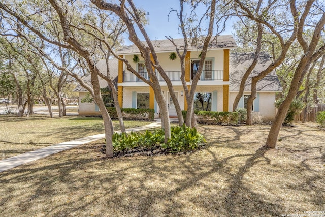 146 Canyon Oaks, Hollywood Park, TX 78232 - view of front of home featuring brick siding, a balcony, and roof with shingles