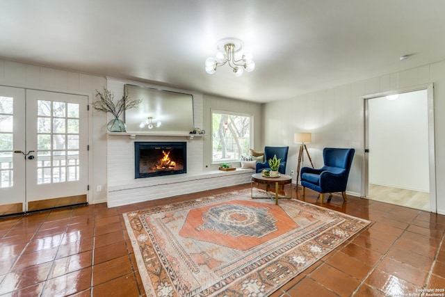146 Canyon Oaks, Hollywood Park, TX 78232 - living area featuring a fireplace, a chandelier, tile patterned flooring, and french doors
