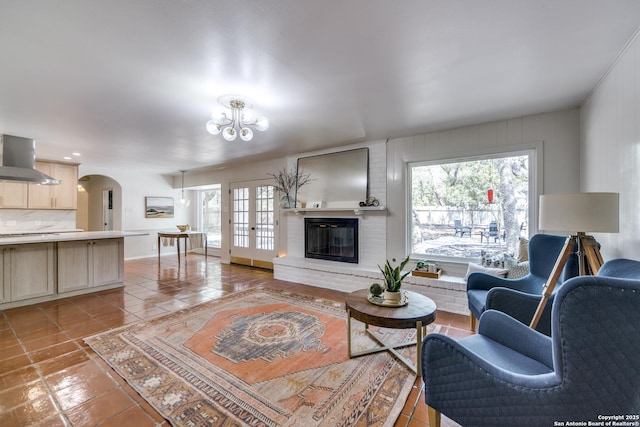 146 Canyon Oaks, Hollywood Park, TX 78232 - living room featuring healthy amount of natural light, light tile patterned floors, and a chandelier