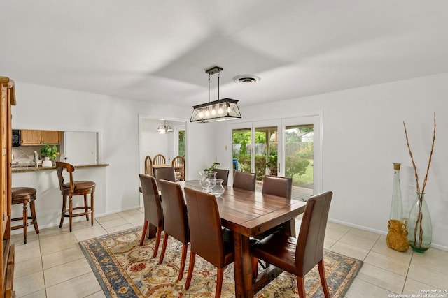 437 Spaceway, Windcrest, TX 78239 - dining area featuring light tile patterned floors, a chandelier, and baseboards