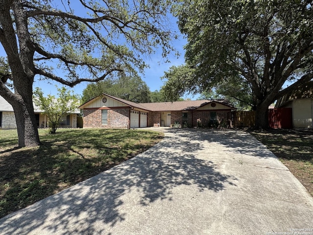 6917 Deep Lk, San Antonio, TX 78244 - single story home featuring concrete driveway, an attached garage, brick siding, and board and batten siding