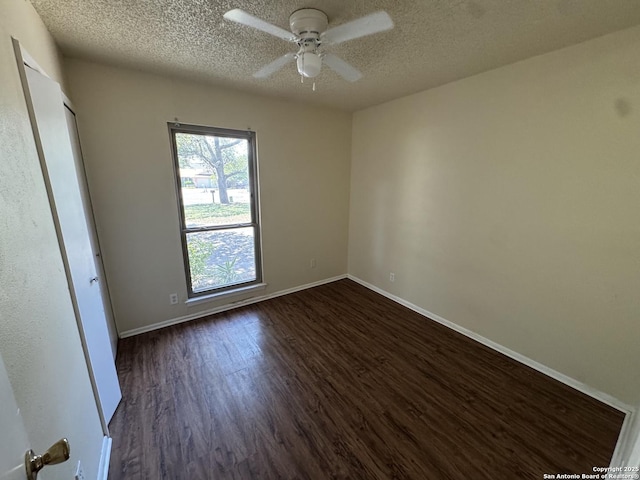 6917 Deep Lk, San Antonio, TX 78244 - unfurnished bedroom featuring dark wood-style floors, a textured ceiling, baseboards, and a ceiling fan