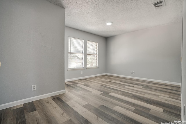 2310 Ruby Oaks, San Antonio, TX 78232 - unfurnished room with a textured ceiling, wood finished floors, and baseboards