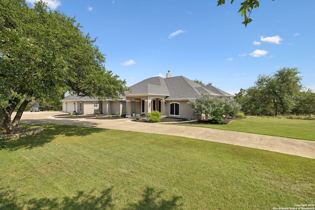 2803 River Way, Spring Branch, TX 78070 - french country style house featuring driveway, a garage, a front lawn, a chimney, and stucco siding