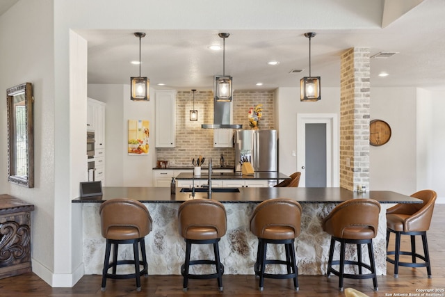 2803 River Way, Spring Branch, TX 78070 - kitchen with appliances with stainless steel finishes, dark countertops, ornate columns, dark wood-type flooring, and white cabinets