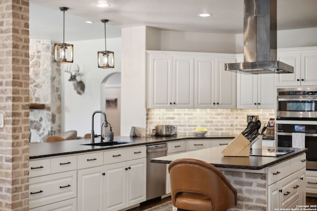 2803 River Way, Spring Branch, TX 78070 - kitchen featuring island exhaust hood, appliances with stainless steel finishes, a sink, dark countertops, and white cabinets