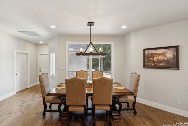 2803 River Way, Spring Branch, TX 78070 - dining room with wood finished floors, baseboards, recessed lighting, and a textured ceiling
