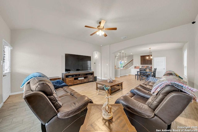 2015 Sisyphus, San Antonio, TX 78245 - living area with arched walkways, a chandelier, light wood-style flooring, ceiling fan, and baseboards
