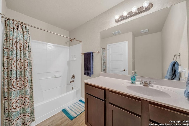 2015 Sisyphus, San Antonio, TX 78245 - bathroom featuring vanity, shower / tub combo, and wood finished floors