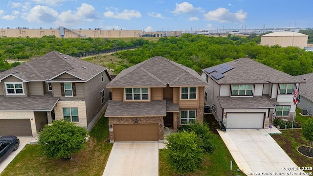 2015 Sisyphus, San Antonio, TX 78245 - view of front facade featuring a garage, driveway, brick siding, and roof with shingles