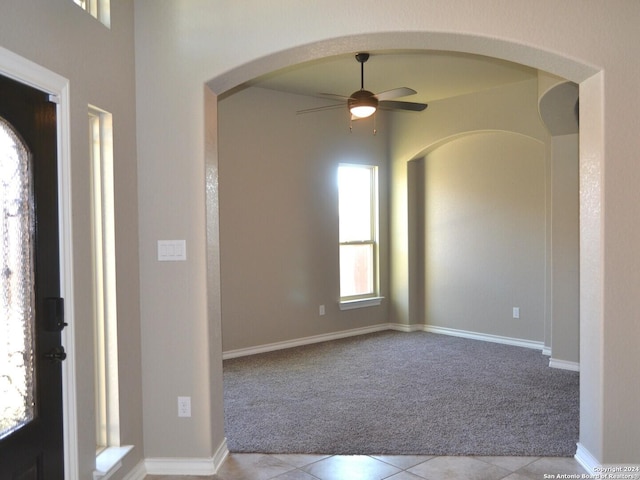 12118 Fort Leaton, San Antonio, TX 78254 - entryway featuring light carpet, a ceiling fan, light tile patterned floors, and arched walkways