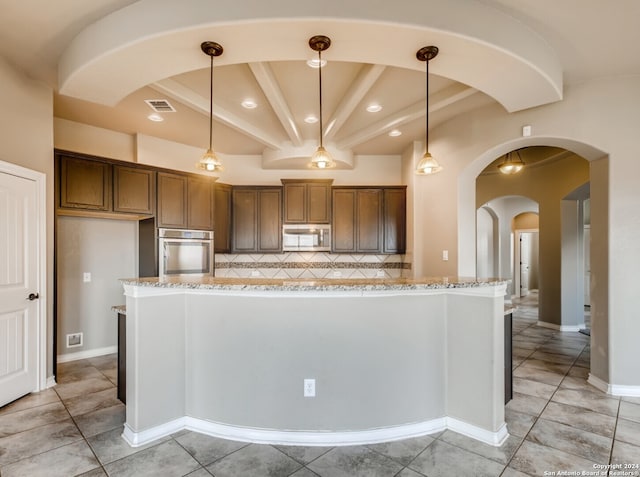 12118 Fort Leaton, San Antonio, TX 78254 - kitchen with stainless steel appliances, arched walkways, tasteful backsplash, light stone countertops, and recessed lighting