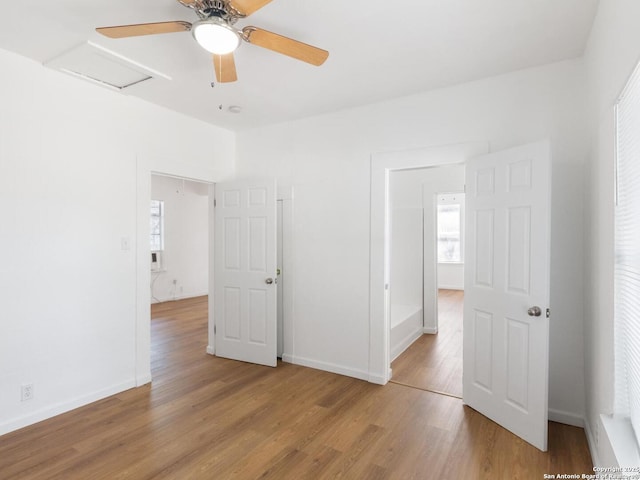 427 Goodrich, San Antonio, TX 78201 - unfurnished bedroom featuring attic access, wood finished floors, baseboards, and a ceiling fan
