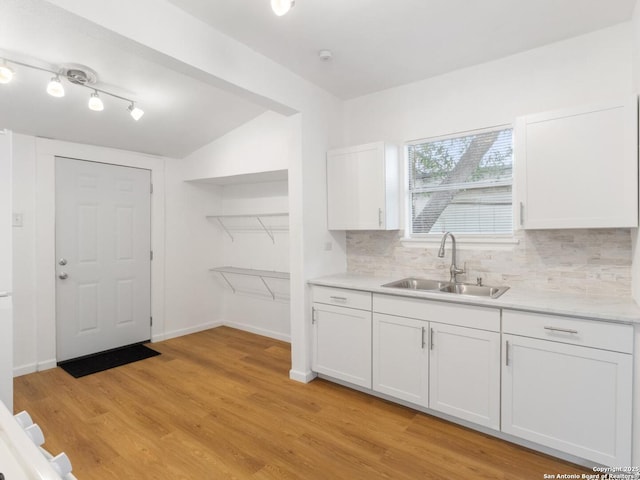 427 Goodrich, San Antonio, TX 78201 - kitchen featuring a sink, white cabinetry, backsplash, light countertops, and lofted ceiling