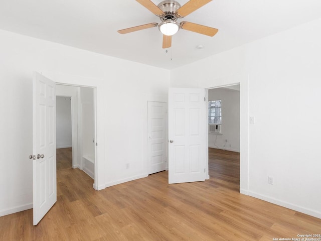 427 Goodrich, San Antonio, TX 78201 - unfurnished bedroom featuring light wood-type flooring, baseboards, and a ceiling fan