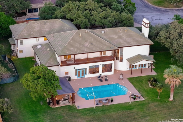 625 Paseo Canada, San Antonio, TX 78232 - back of house with a balcony, a patio, a lawn, stucco siding, and an outdoor pool