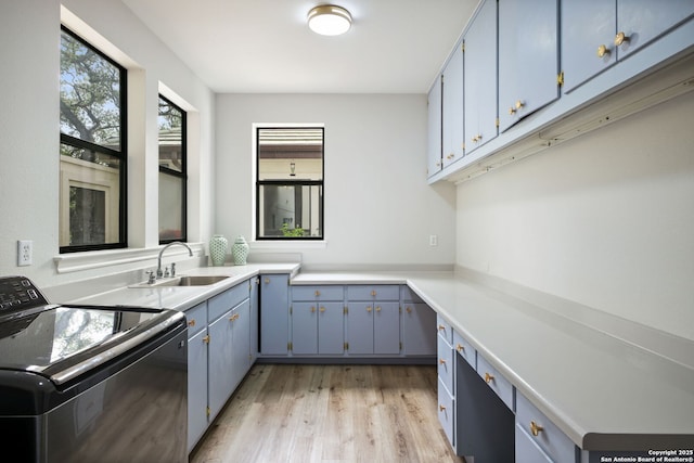 625 Paseo Canada, San Antonio, TX 78232 - laundry room with washer / dryer, cabinet space, and light wood-type flooring