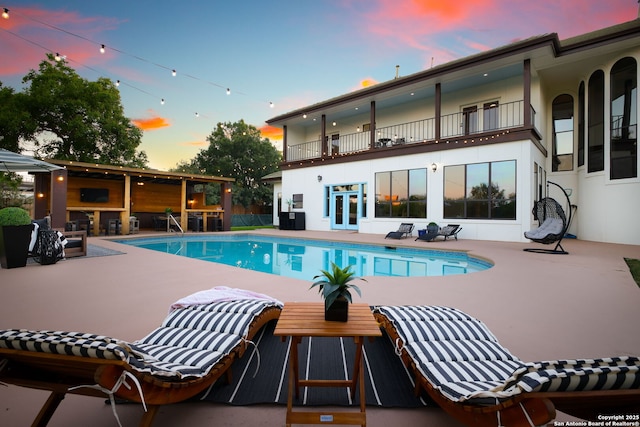 625 Paseo Canada, San Antonio, TX 78232 - pool at dusk with a patio area, an outdoor pool, and french doors