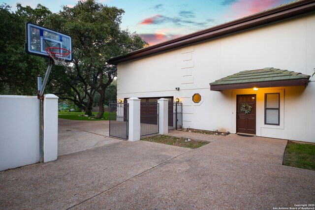 625 Paseo Canada, San Antonio, TX 78232 - property exterior at dusk featuring a gate and stucco siding