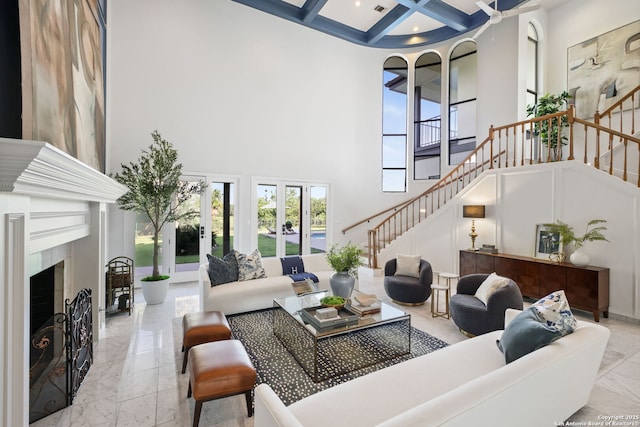 625 Paseo Canada, San Antonio, TX 78232 - living room featuring a towering ceiling, marble tiled flooring, stairs, coffered ceiling, and a fireplace with raised hearth