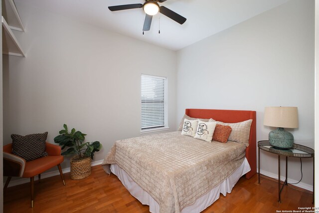 625 Paseo Canada, San Antonio, TX 78232 - bedroom featuring baseboards, wood finished floors, and a ceiling fan