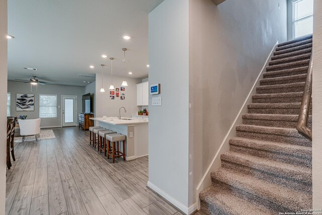 10206 Daylily, Boerne, TX 78006 - stairs with baseboards, wood finished floors, ceiling fan, and recessed lighting