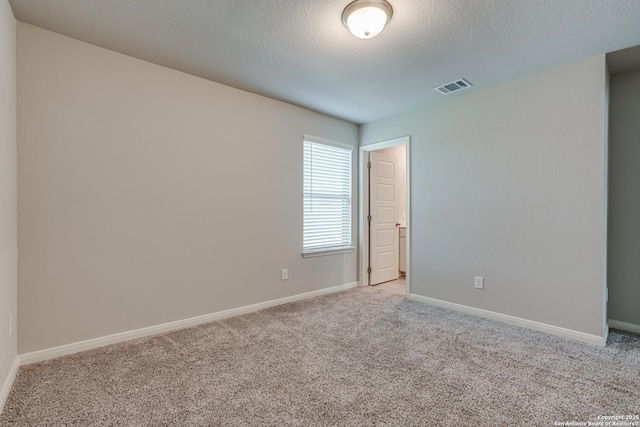 10206 Daylily, Boerne, TX 78006 - empty room with light carpet, baseboards, and a textured ceiling