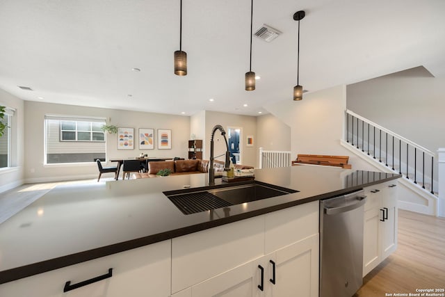 1618 W Lawndale Unit, San Antonio, TX 78209 - kitchen featuring stainless steel dishwasher, a sink, dark countertops, open floor plan, and recessed lighting