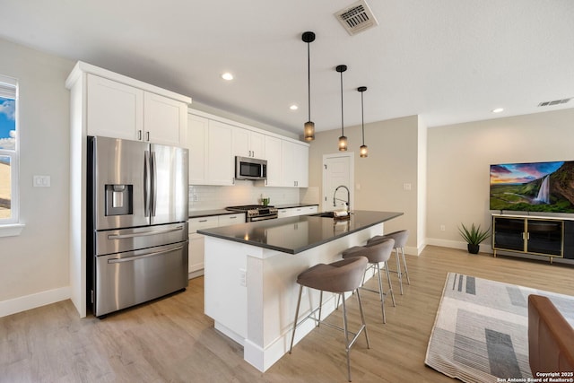 1618 W Lawndale Unit, San Antonio, TX 78209 - kitchen featuring appliances with stainless steel finishes, dark countertops, baseboards, light wood-style flooring, and recessed lighting